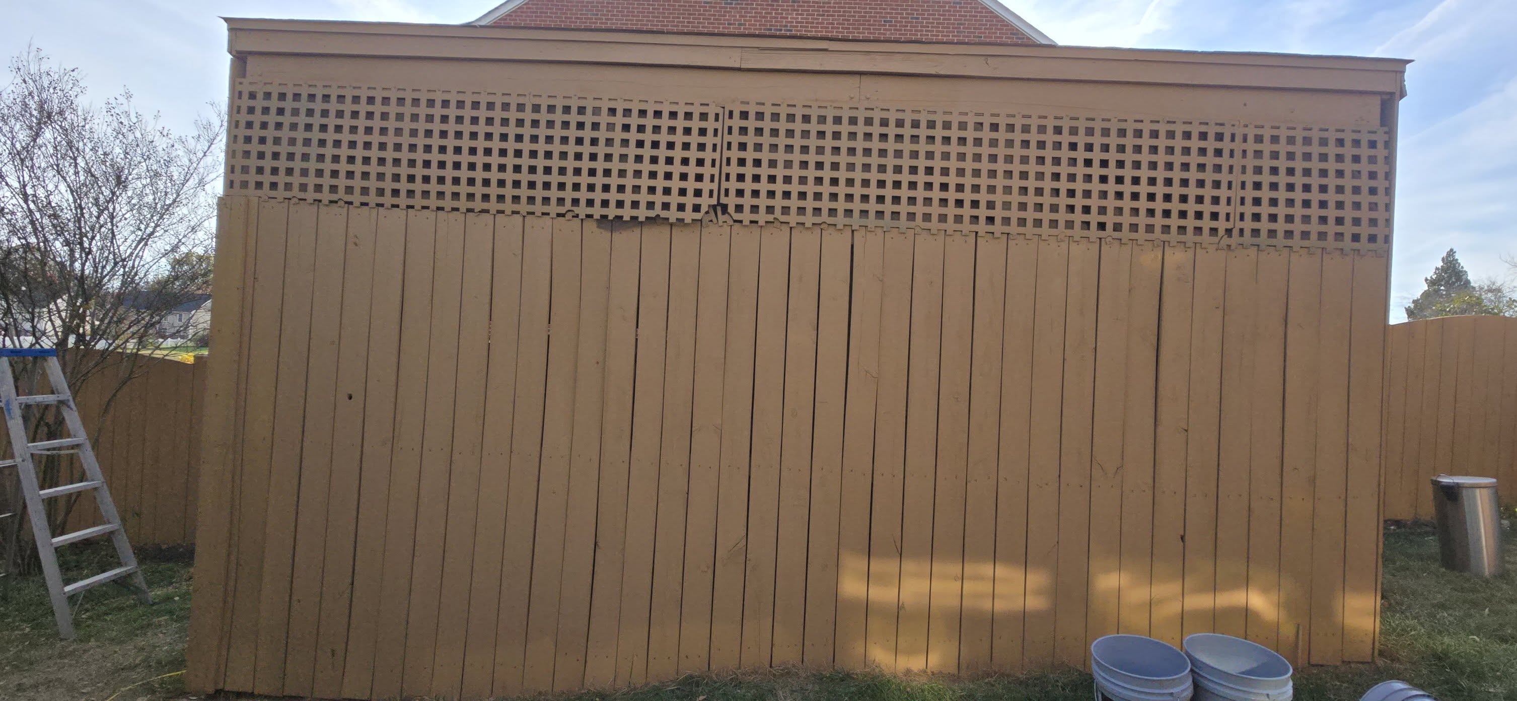Freshly painted privacy fence by Flower's Cleaning and Handyman Service