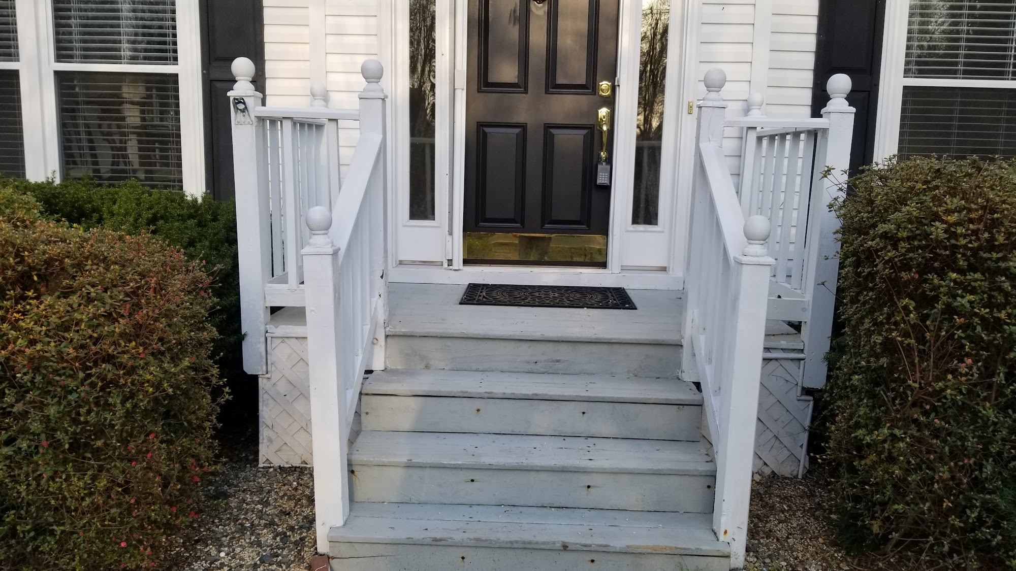 Painted front porch railing and entry steps after exterior maintenance