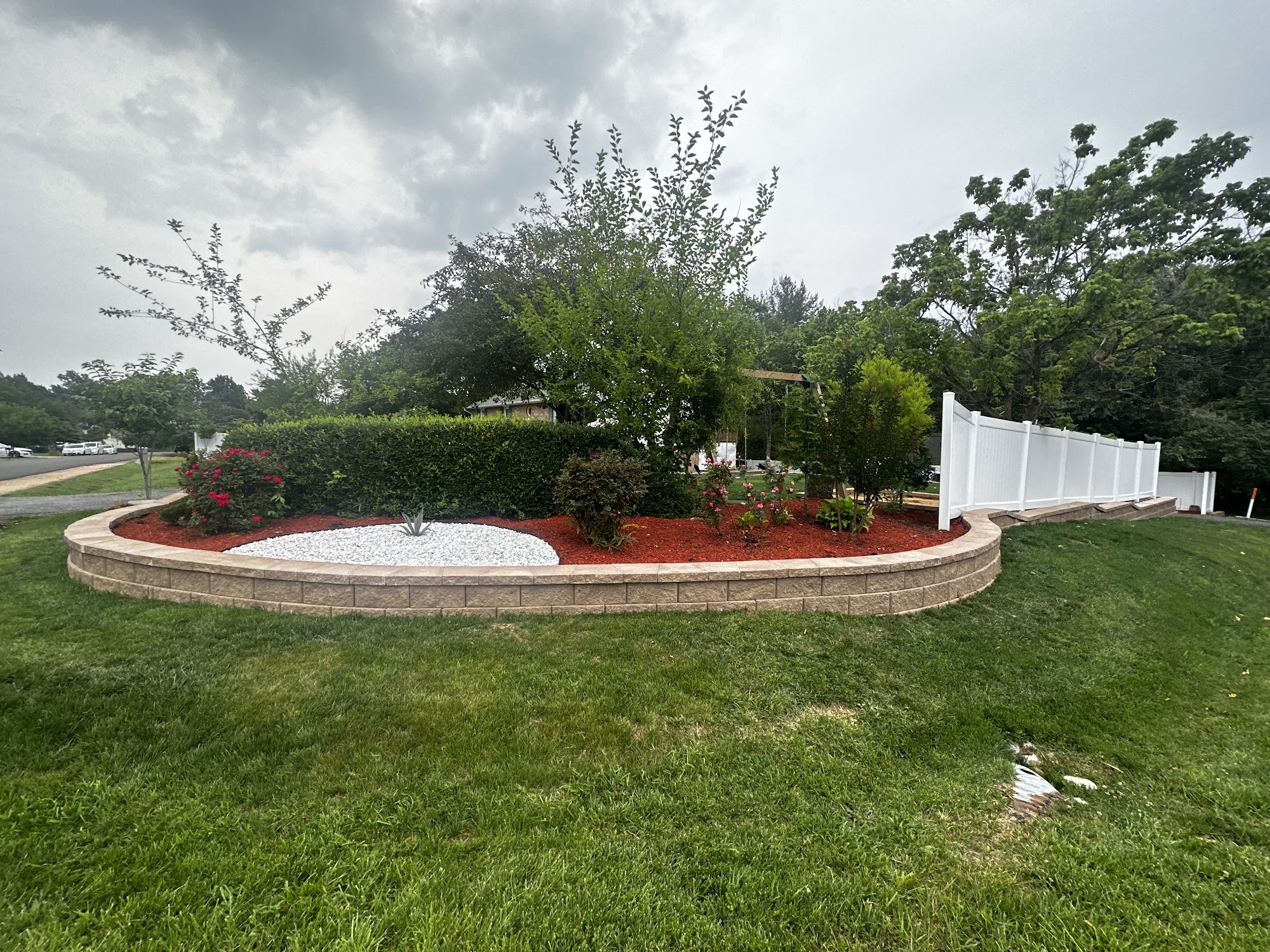 Finished raised landscape bed with stone border and fresh mulch