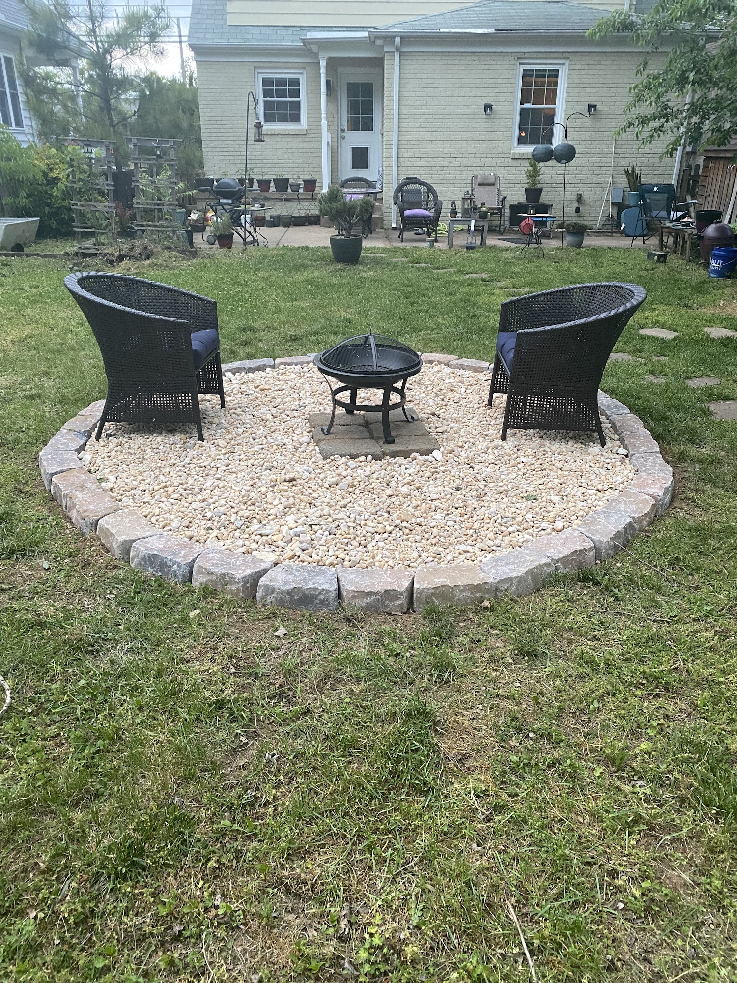 Gravel fire pit sitting area with stone edging