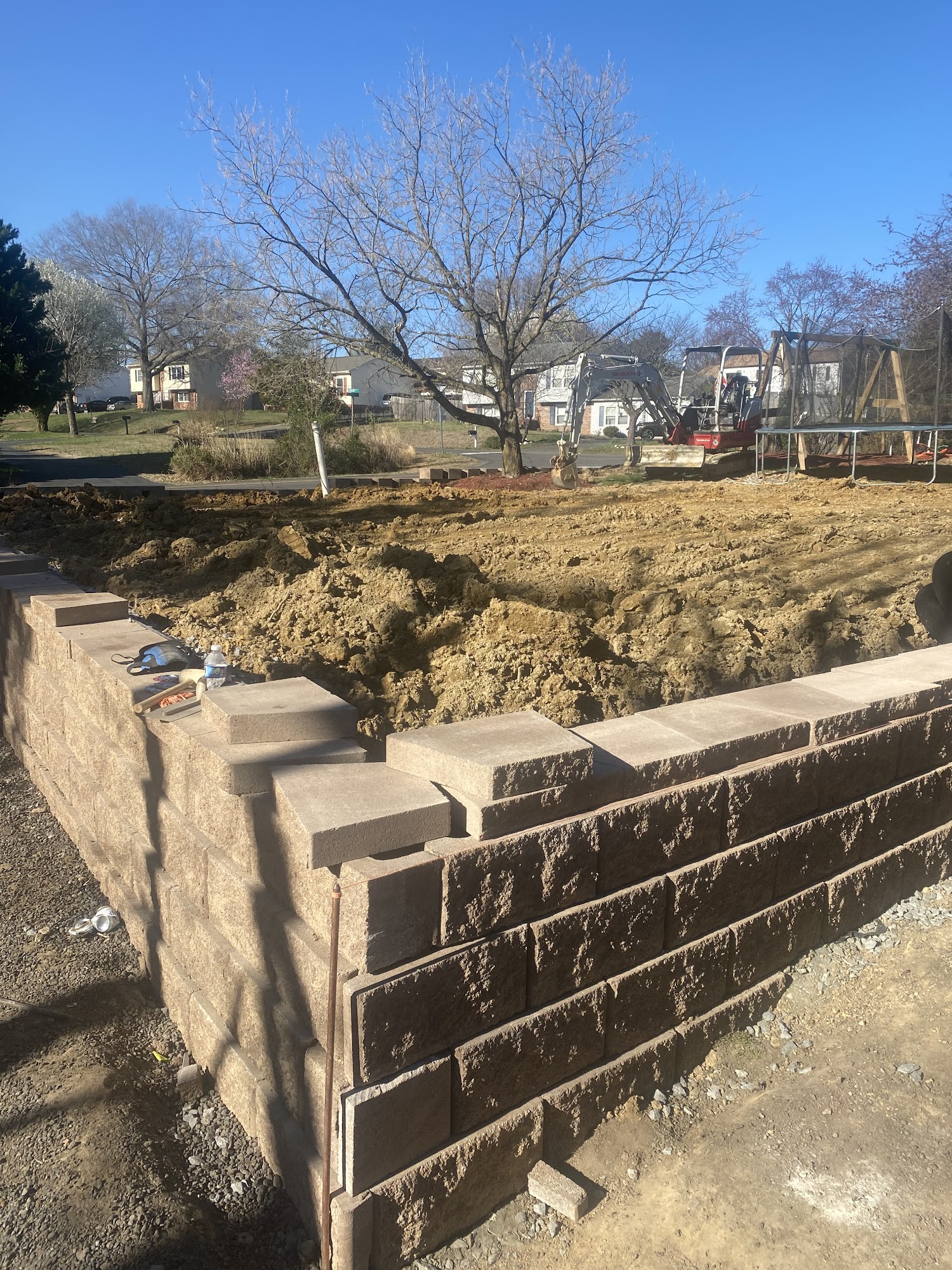 Retaining wall under construction in a backyard
